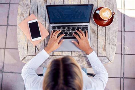 A content creator writing a detailed blog post on a laptop at home