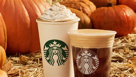 A Starbucks Pumpkin Spice Latte placed on a wooden table as a seasonal drink