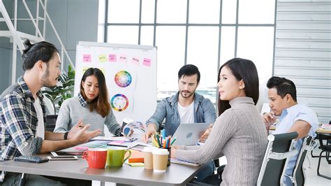 A digital marketing agency team working on multiple computers analyzing data and creating campaigns