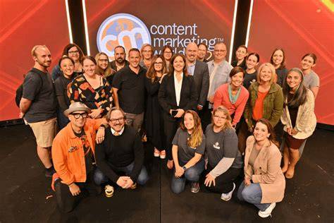 A diverse group of marketing professionals interacting at a content marketing conference.